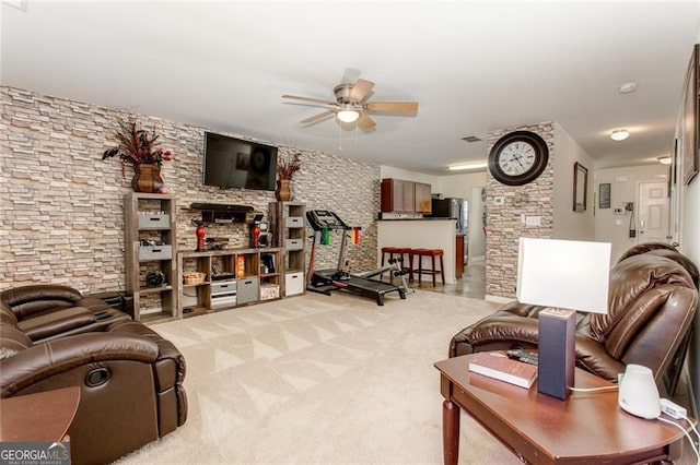 carpeted living room with ceiling fan