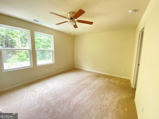 carpeted empty room featuring ceiling fan