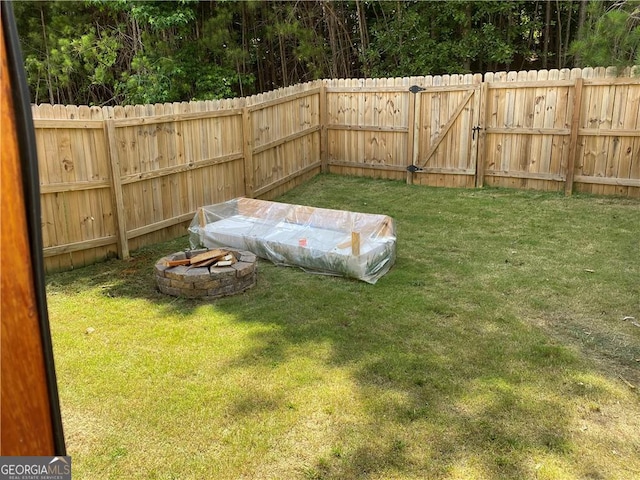 view of yard with an outdoor fire pit