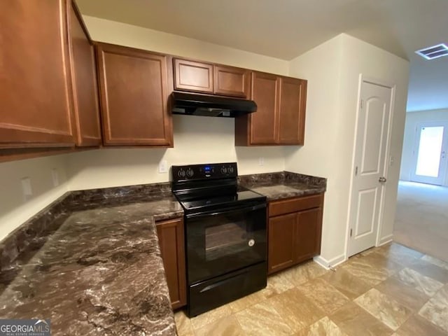 kitchen featuring dark stone counters and black electric range oven