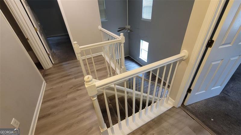 stairway featuring wood-type flooring