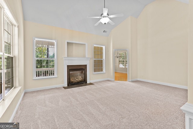 unfurnished living room with ceiling fan, light carpet, and high vaulted ceiling