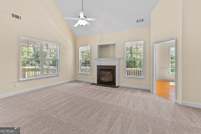 unfurnished living room with ceiling fan, light colored carpet, and high vaulted ceiling