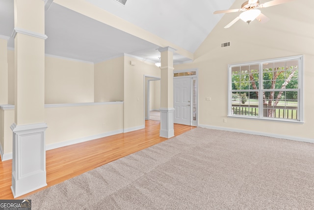 spare room featuring high vaulted ceiling, light hardwood / wood-style floors, ceiling fan, and ornate columns