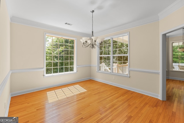 unfurnished dining area featuring ornamental molding, light wood-type flooring, and a healthy amount of sunlight