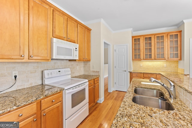 kitchen featuring ornamental molding, light hardwood / wood-style floors, sink, and white appliances