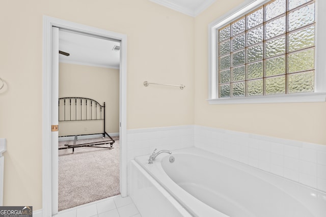 bathroom featuring tile patterned floors, a bathtub, and crown molding