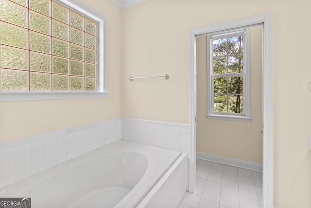 bathroom featuring ornamental molding, a bathing tub, and tile patterned flooring