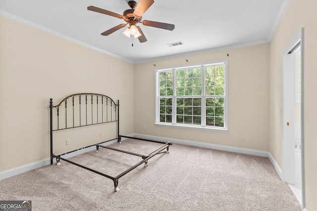 unfurnished bedroom with ornamental molding, ceiling fan, and light colored carpet