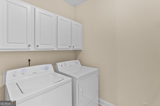 laundry room with cabinets and washing machine and dryer