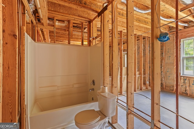 bathroom featuring shower / tub combination and toilet