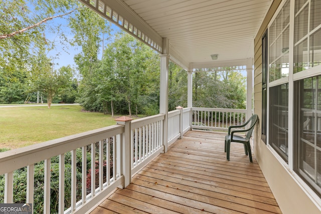 wooden deck with a yard and a porch