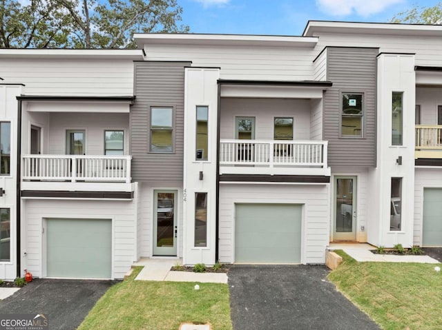 view of property with a balcony and a garage