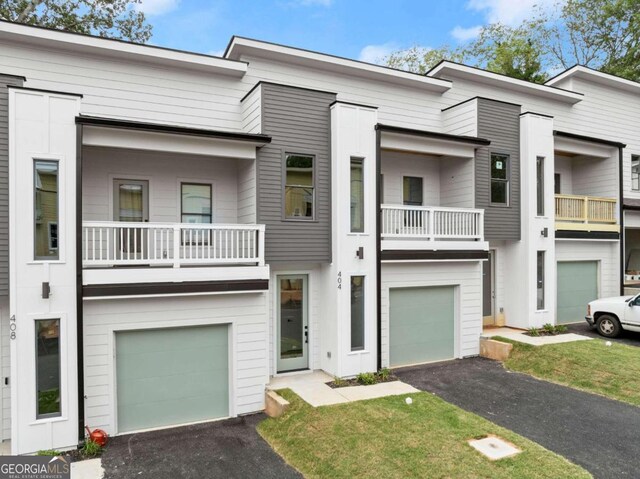 view of property with a balcony and a garage