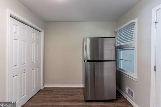 kitchen featuring dark hardwood / wood-style floors and stainless steel fridge