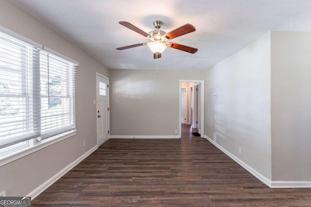 interior space with ceiling fan and dark hardwood / wood-style floors