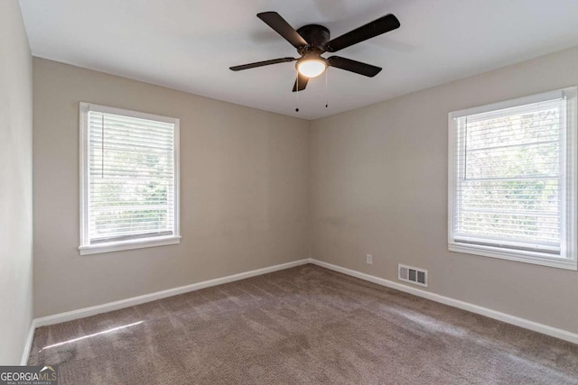 empty room featuring ceiling fan and carpet flooring