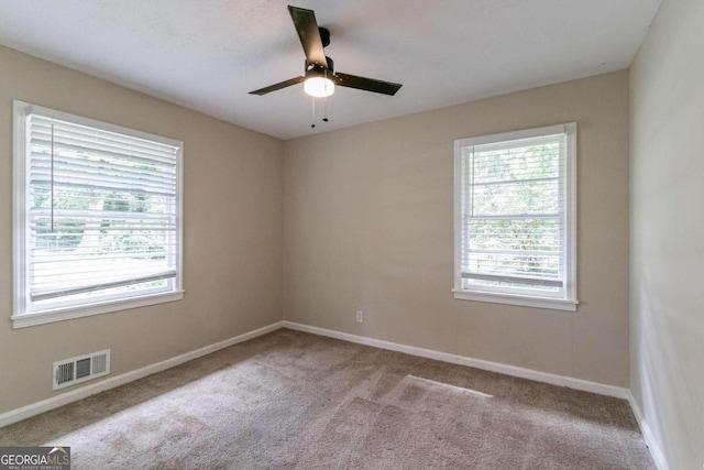 carpeted empty room featuring ceiling fan