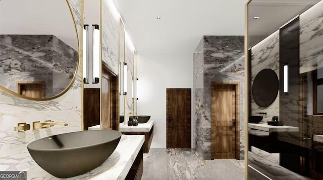 bathroom featuring vanity and tile walls