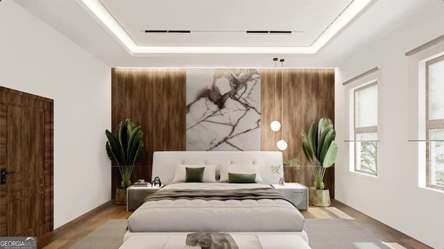 bedroom with a tray ceiling and hardwood / wood-style floors