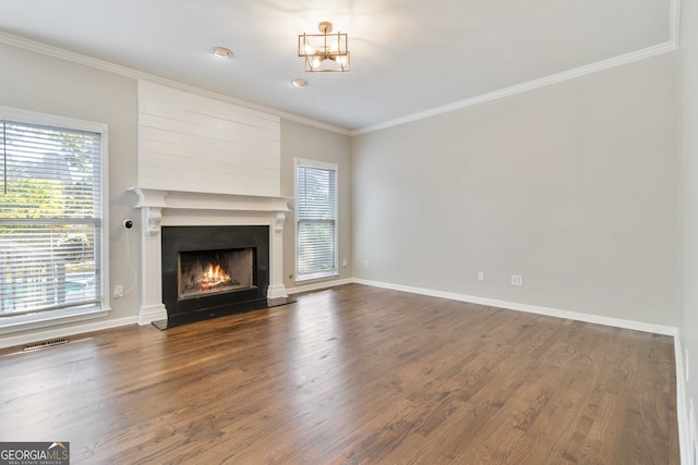 unfurnished living room featuring ornamental molding, a fireplace, a chandelier, and dark wood-type flooring