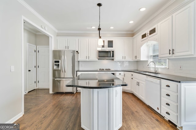 kitchen with a center island, dark wood-type flooring, sink, white cabinetry, and stainless steel appliances