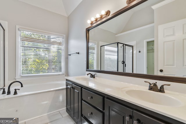 bathroom featuring vanity, lofted ceiling, and a healthy amount of sunlight