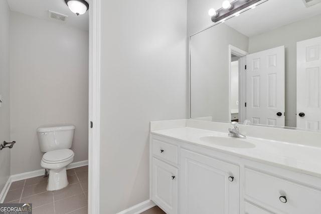 bathroom featuring tile patterned floors, vanity, and toilet