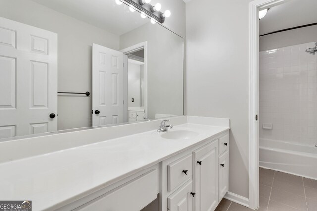 bathroom featuring vanity, tiled shower / bath combo, and tile patterned flooring