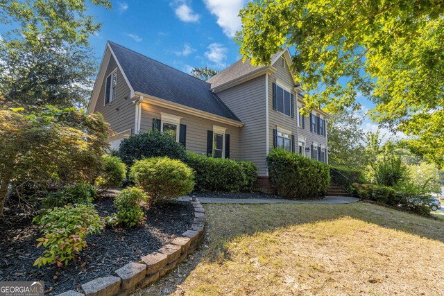 view of property exterior with a yard