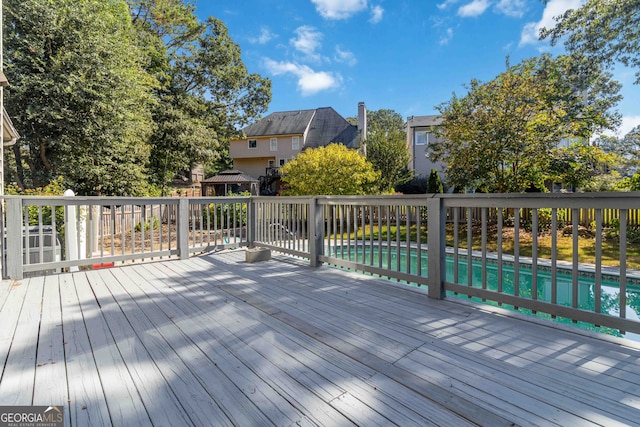 deck featuring a gazebo and a fenced in pool