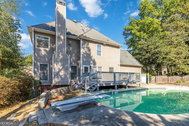 rear view of house with a patio and a pool side deck