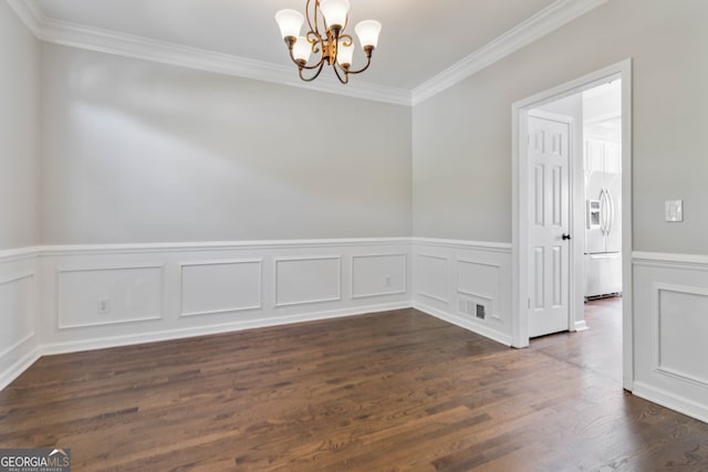 empty room featuring ornamental molding, dark hardwood / wood-style flooring, and a notable chandelier