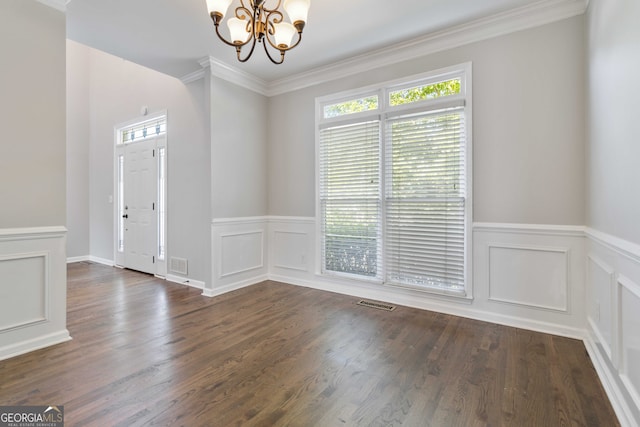 unfurnished room with a notable chandelier, dark hardwood / wood-style floors, and crown molding