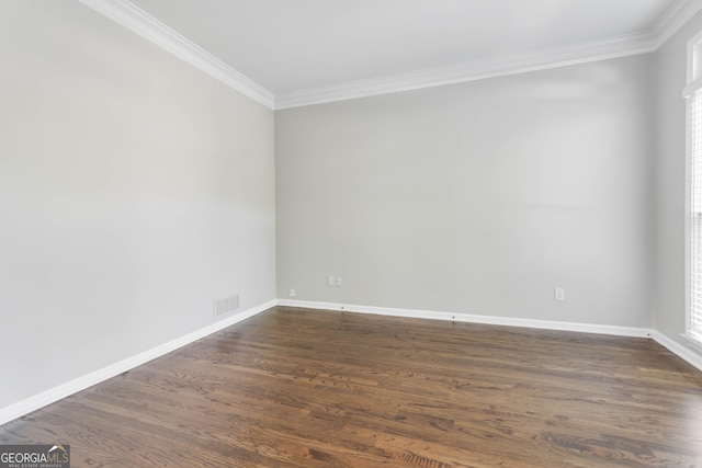 spare room with dark hardwood / wood-style floors, a healthy amount of sunlight, and crown molding