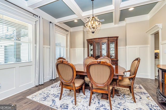 dining area featuring dark wood-type flooring, ornamental molding, beam ceiling, and a notable chandelier