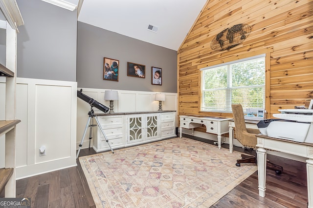 office with high vaulted ceiling, wood walls, and hardwood / wood-style floors