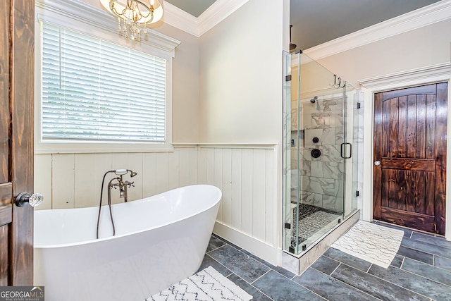 bathroom with an inviting chandelier, shower with separate bathtub, and crown molding