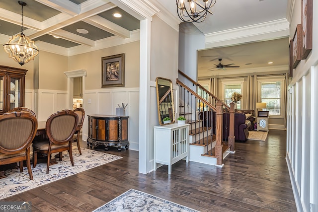 interior space featuring beamed ceiling, dark hardwood / wood-style flooring, ceiling fan with notable chandelier, crown molding, and coffered ceiling