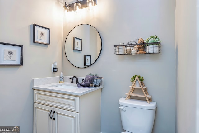 bathroom featuring vanity and toilet