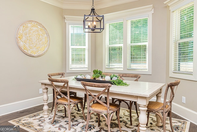 dining space featuring ornamental molding, plenty of natural light, an inviting chandelier, and dark hardwood / wood-style floors