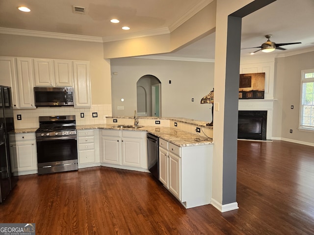 kitchen with stainless steel appliances, kitchen peninsula, dark wood-type flooring, and white cabinetry