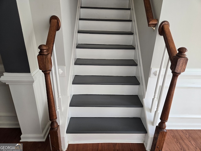 stairs featuring wood-type flooring