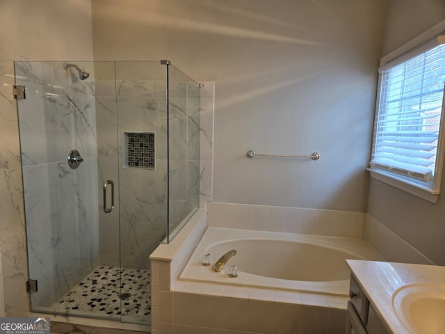 bathroom featuring shower with separate bathtub and vanity