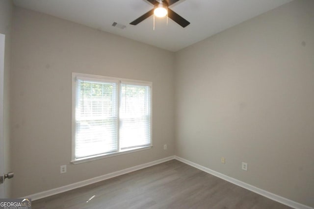 unfurnished room featuring hardwood / wood-style floors and ceiling fan