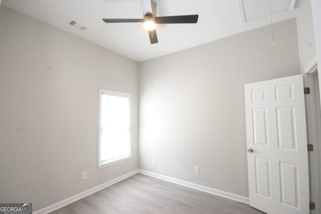 spare room with light hardwood / wood-style floors and ceiling fan