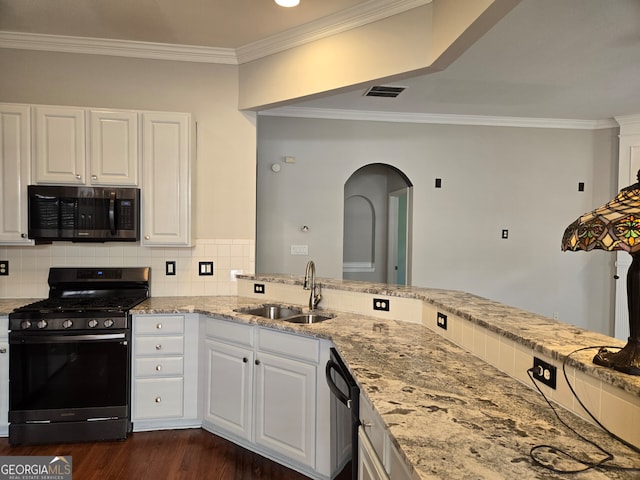 kitchen with sink, tasteful backsplash, white cabinetry, appliances with stainless steel finishes, and dark hardwood / wood-style flooring