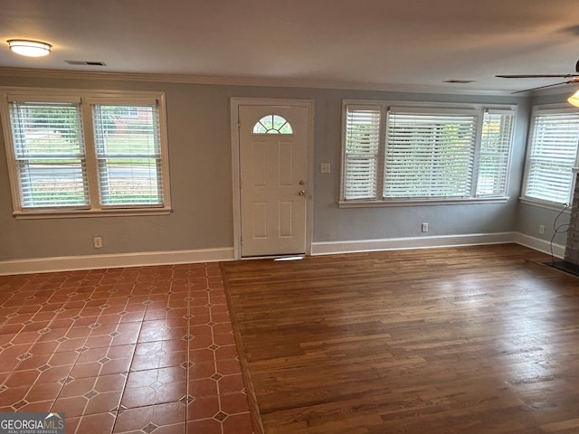 foyer featuring ornamental molding, dark hardwood / wood-style flooring, and ceiling fan