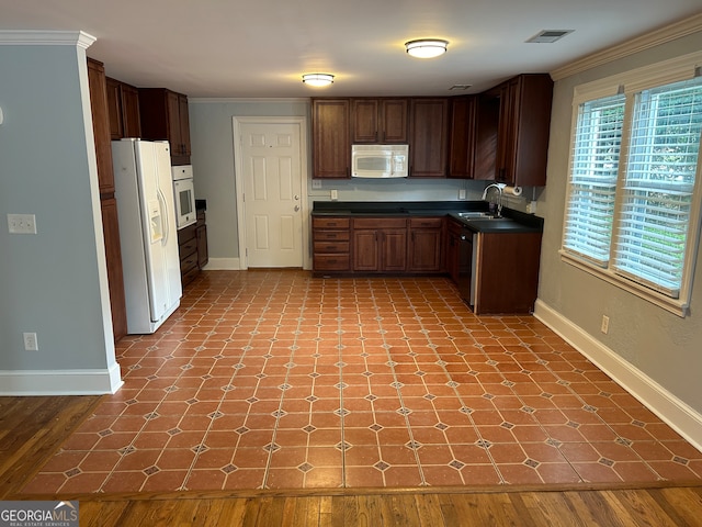 kitchen featuring light hardwood / wood-style floors, crown molding, sink, and white appliances