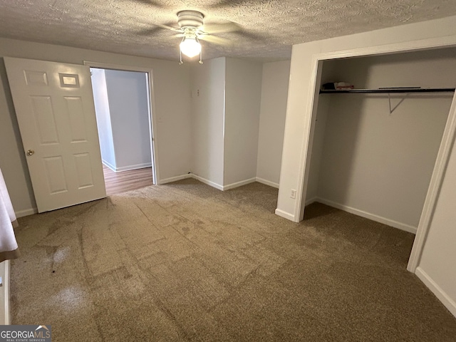 unfurnished bedroom with carpet flooring, a closet, ceiling fan, and a textured ceiling